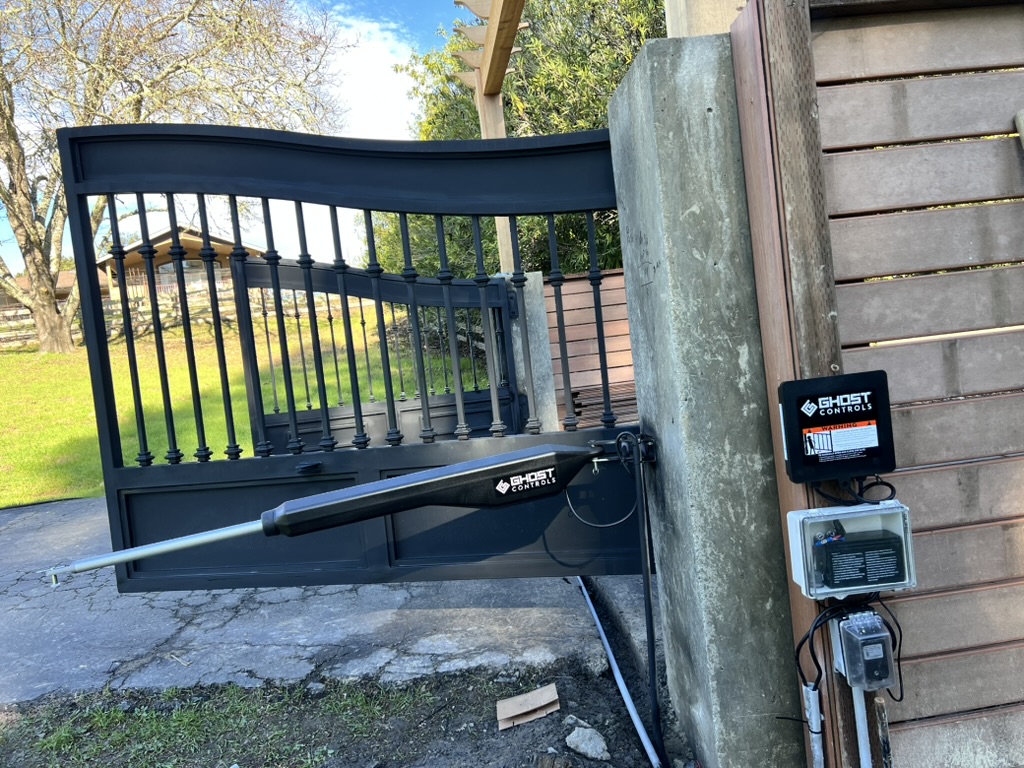 Technician repairing an automatic gate